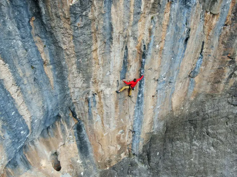 A fearless rock climber conquers a steep cliff face in Leonidio, Greece